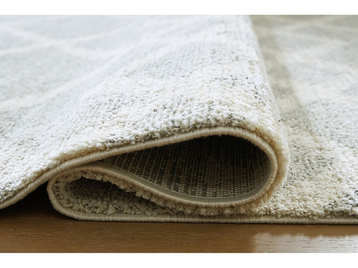 Unawick 5' x 7' Medium Rug in Gray/Ivory